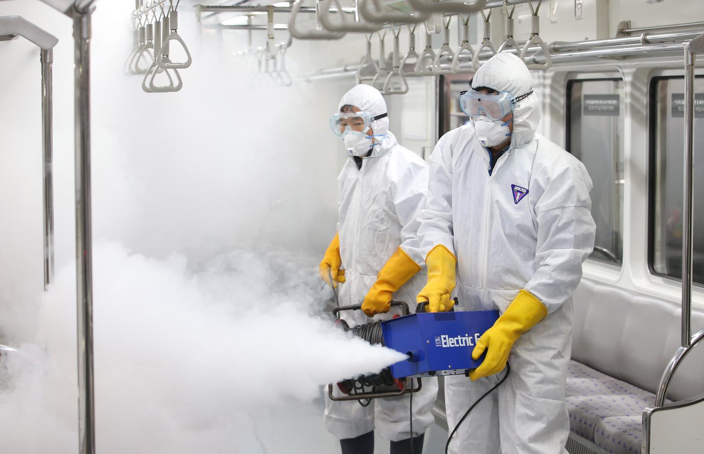 epa05165560 Workers fumigate a train car at a train depot in Seoul's Gangseo Ward, South Korea, 17 February 2016, as a precaution against the spread of the Zika virus (ZIKV). The Centers for Disease Control and Prevention said the same day that the government will launch a nationwide mosquito control program to prevent the import of the mosquito-borne virus. The control efforts will target the Asian tiger mosquito, said to spread the virus that causes microcephaly in unborn children.  EPA/YONHAP SOUTH KOREA OUT